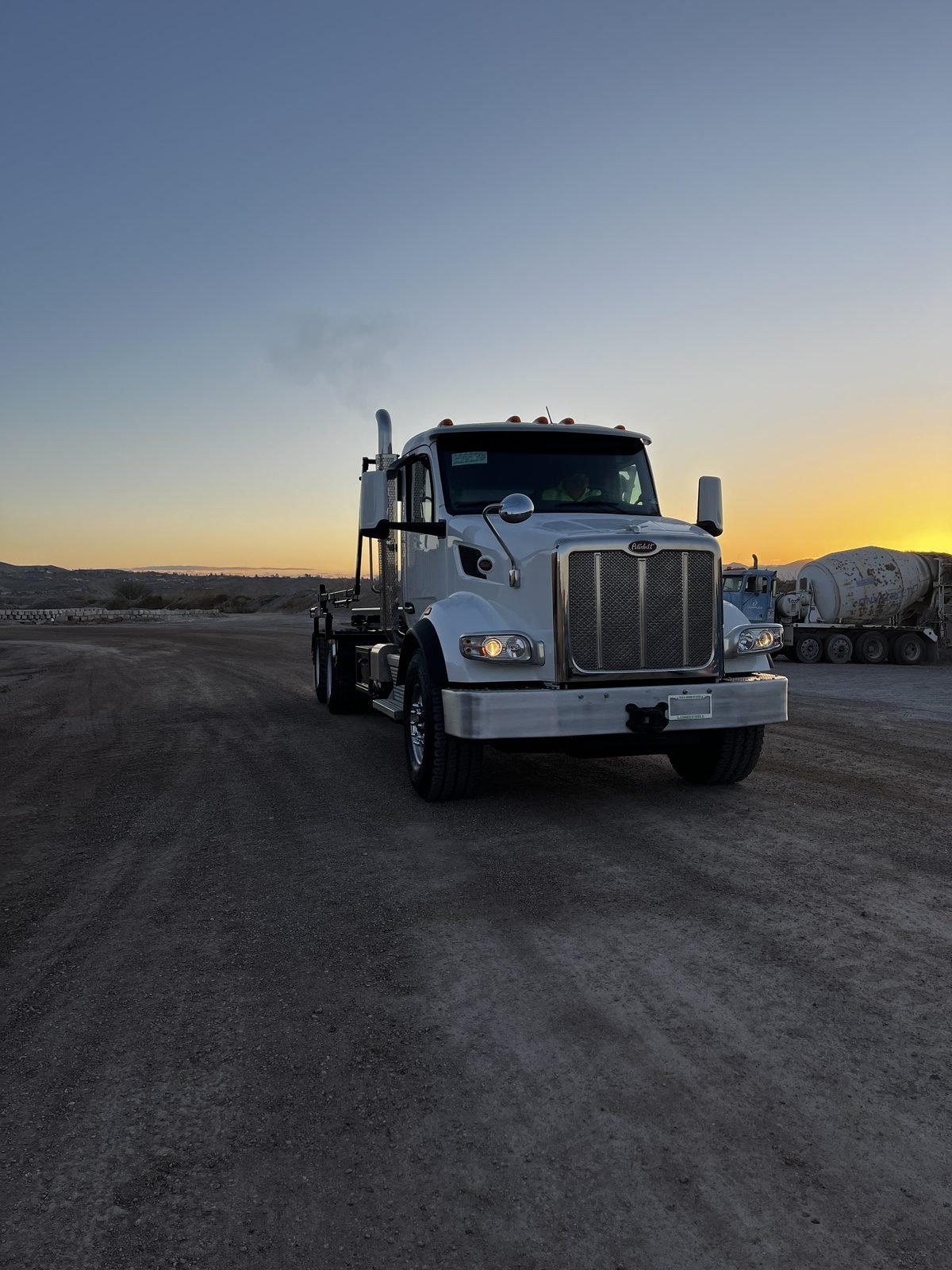 Rock & Roll Roll-Offs Peterbilt roll-off truck at sunset in Southern Arizona
